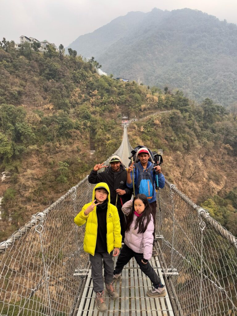 Trekking in Nepal with kids Big Sky Treks kids in suspension bridge